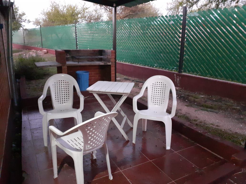 Patio con parrilla, mesa y sillas
